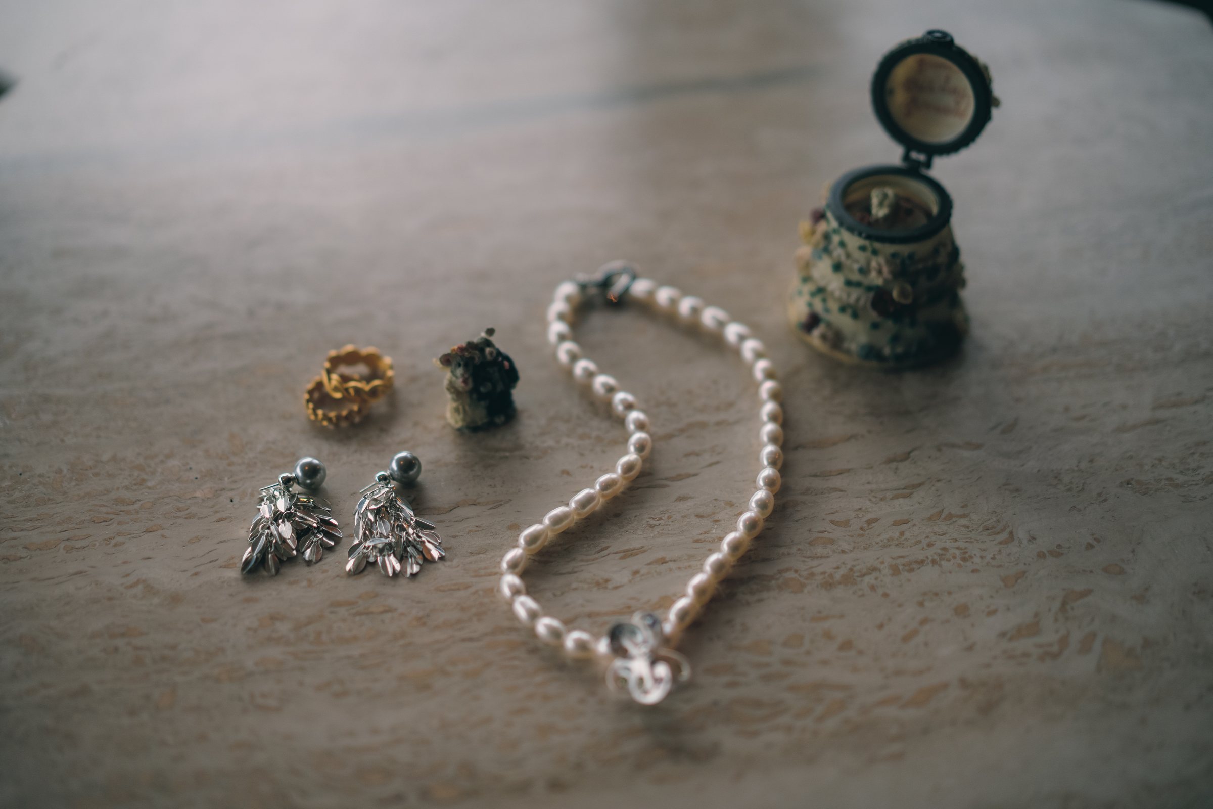 Wedding jewellery arranged in soft window light